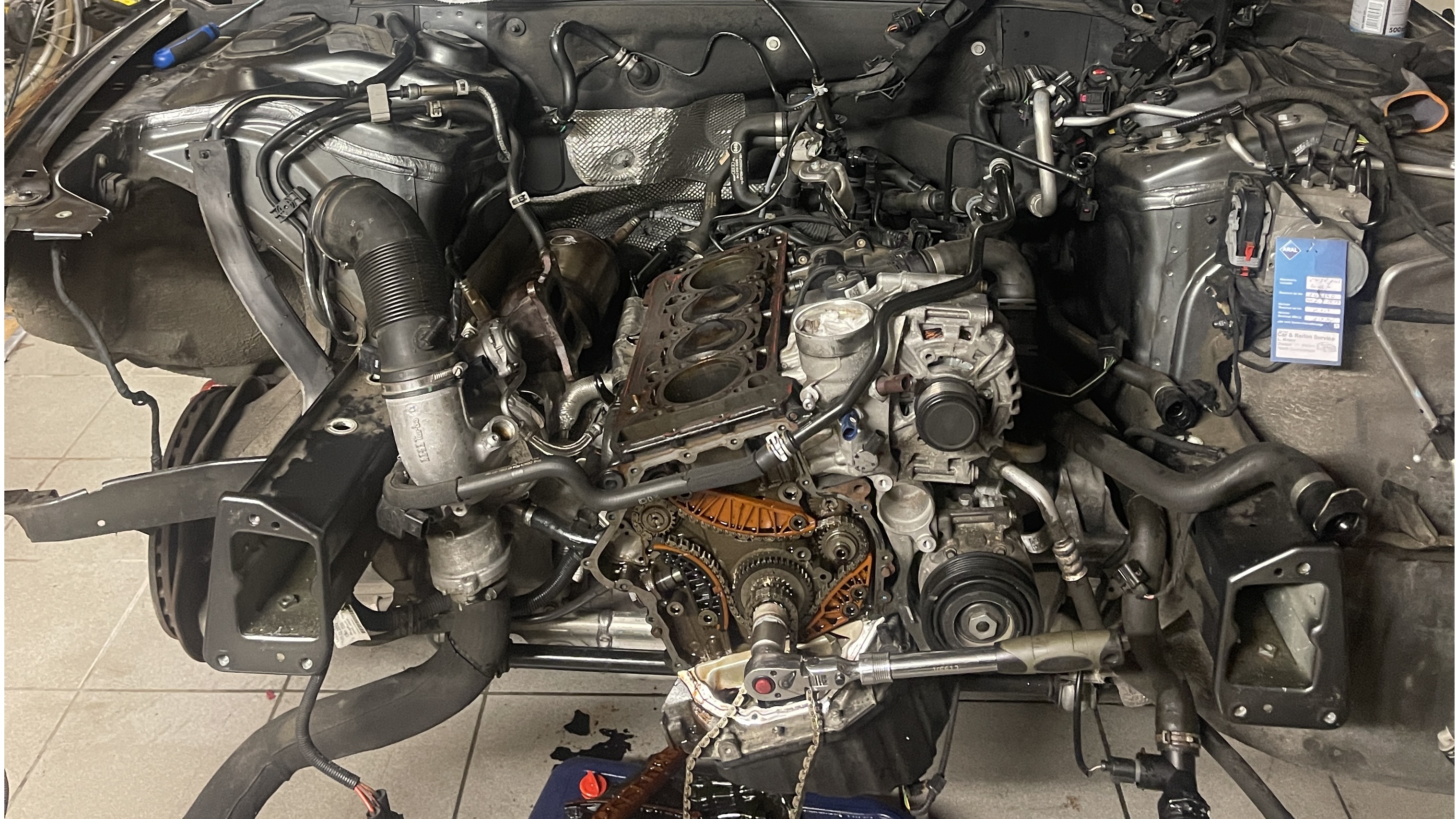 Disassembled engine block showing pistons and cylinder head